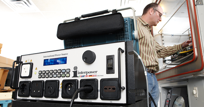 image of man using the interpower international power source to test his export products