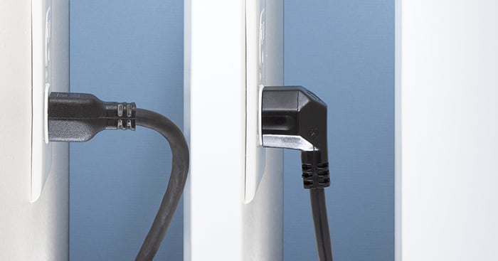 image of standard power cord with cord bent at sharp angle do to lack of space, being compared to an angled NEMA cord in a tight space, where it's cord is not being bent at all.